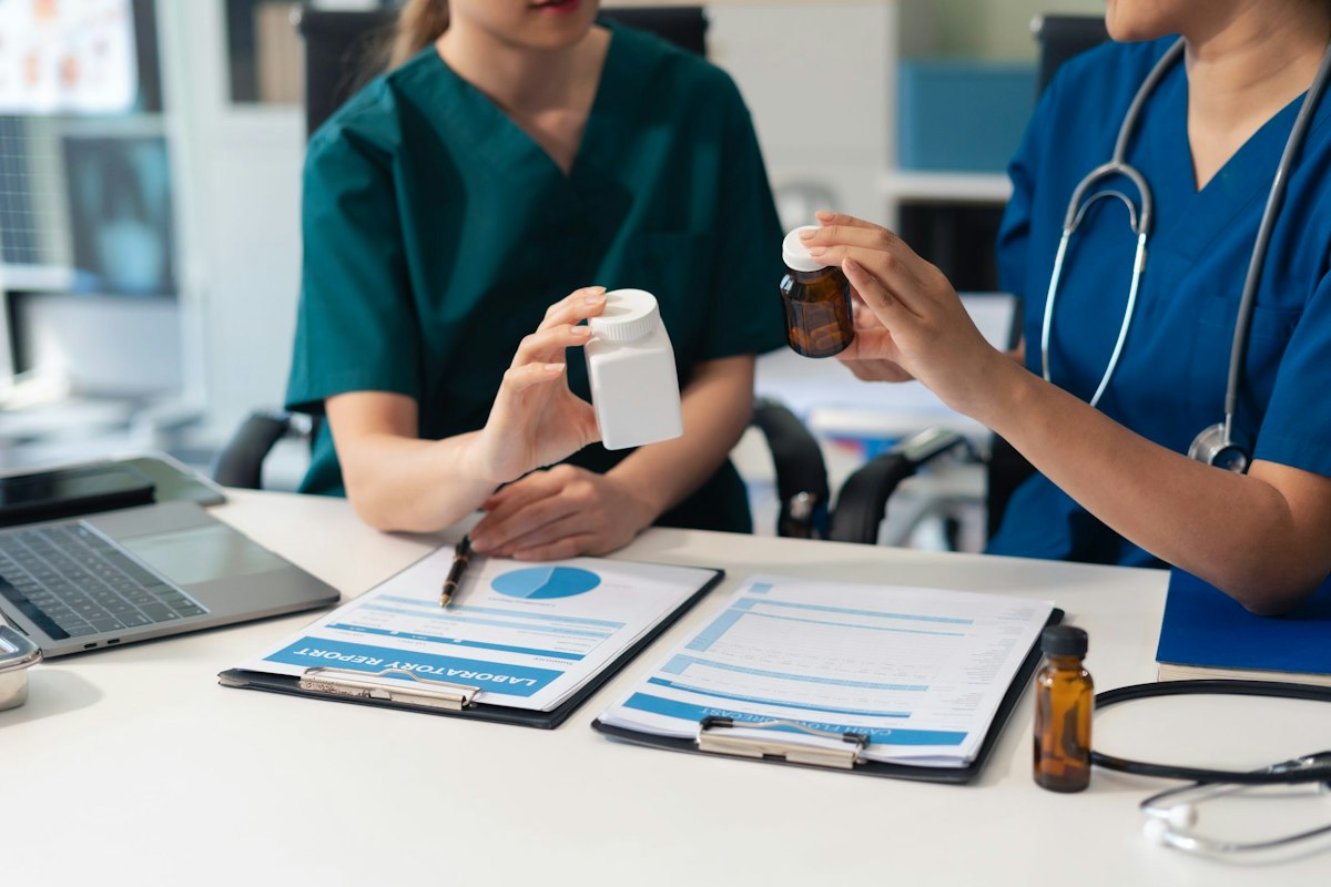 Medical provider reviewing prescription medications with a patient during a physician led medication management visit at Geneva Primary Care in Alpharetta