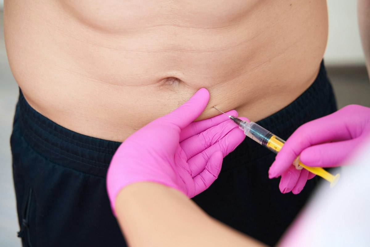 Medical provider administering a physician-guided tirzepatide injection into the abdominal area in a clinical setting