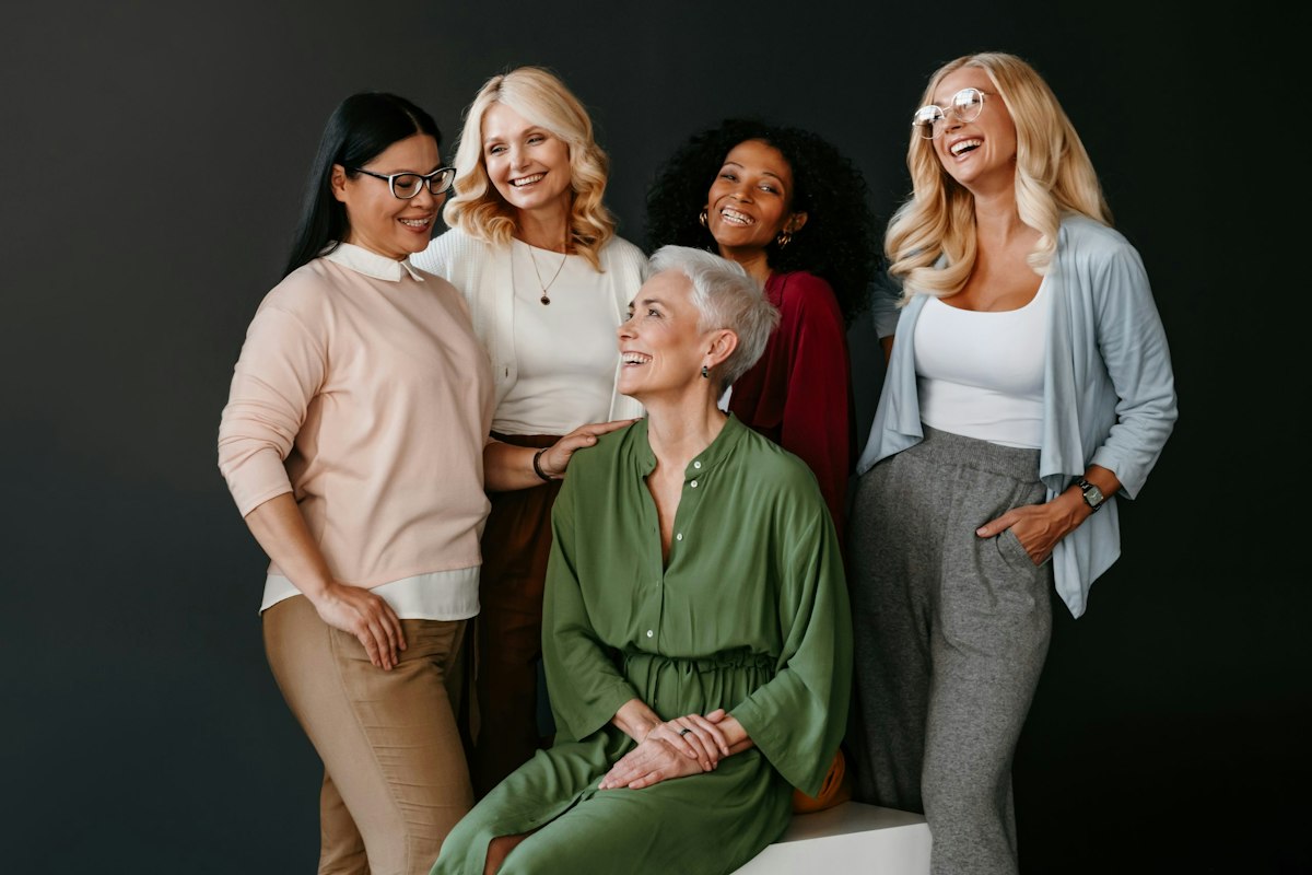 A diverse group of confident midlife women smiling together, representing compassionate and personalized menopause care at Geneva Primary Care and Med Spa in Alpharetta and Johns Creek