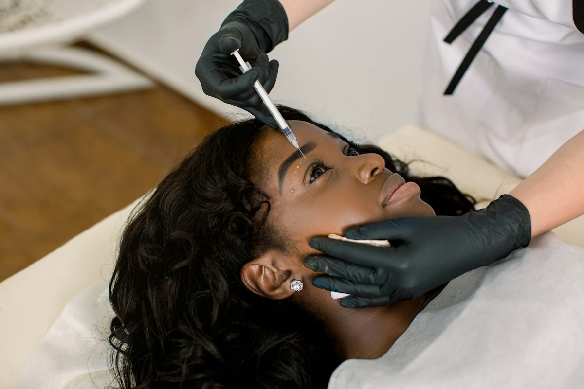 Patient receiving Botox injections around the eye area performed by a medical provider at Geneva Primary Care and Med Spa in Alpharetta