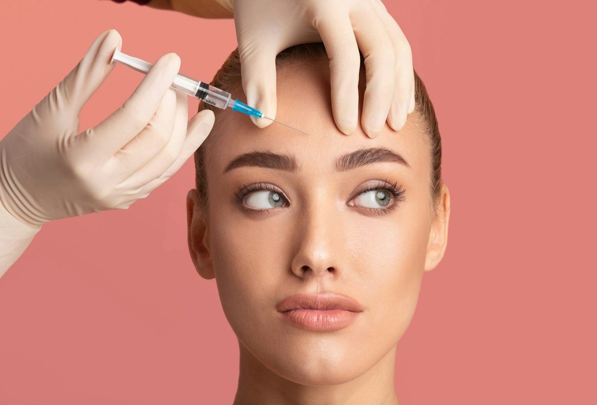 A young woman receiving a precise skin lifting Botox injection at Geneva for natural, refined aesthetic enhancement.