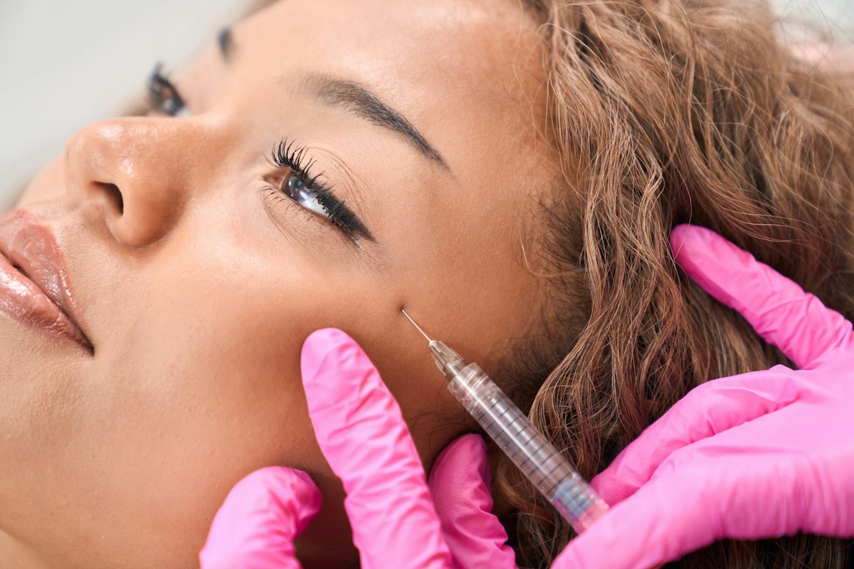 Close up of a woman receiving a Botox injection at Geneva to soften lines and enhance natural facial balance.