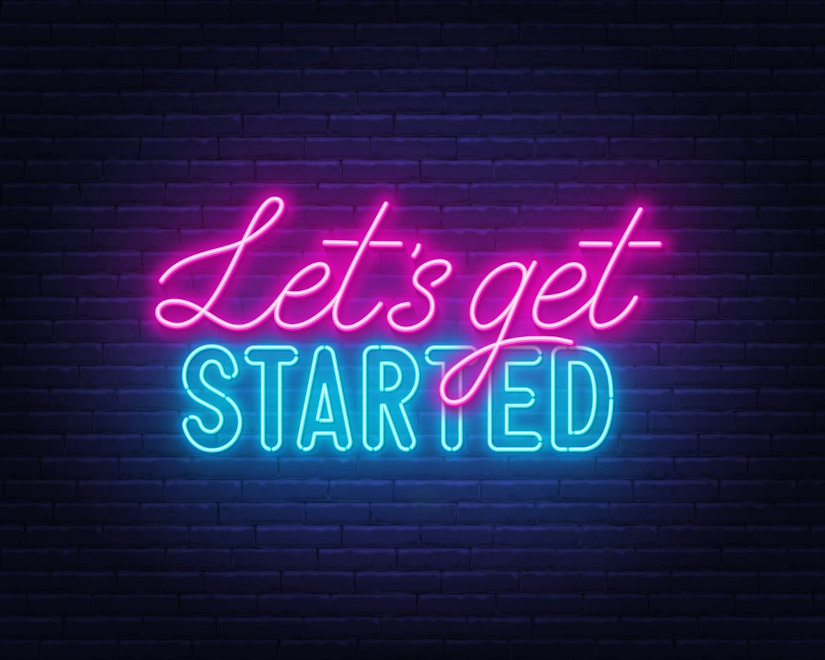 A glowing neon “Let’s Get Started” sign displayed against a brick wall, used to inspire new patient journeys at Geneva.