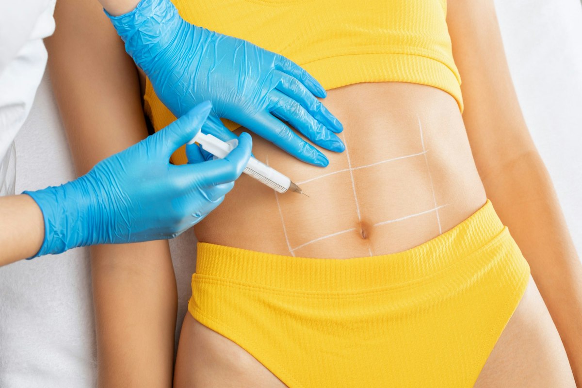 A patient self-administering a medical weight loss injection in the abdominal area under physician guidance at Geneva.