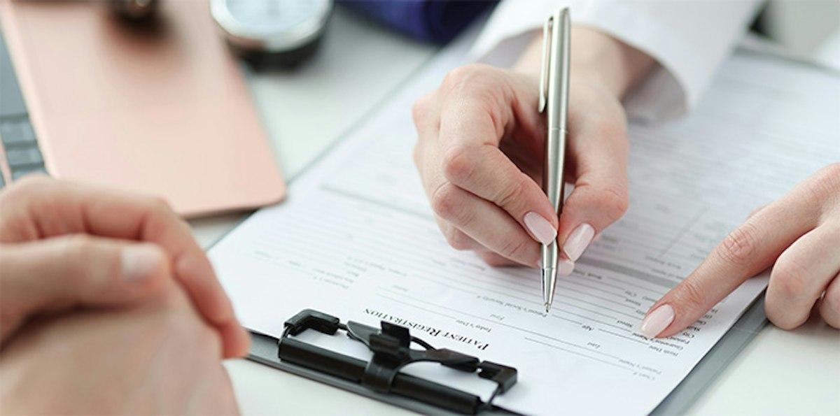 Geneva Physician Documenting a Patient’s Care Plan After a Thoughtful Primary Care Appointment