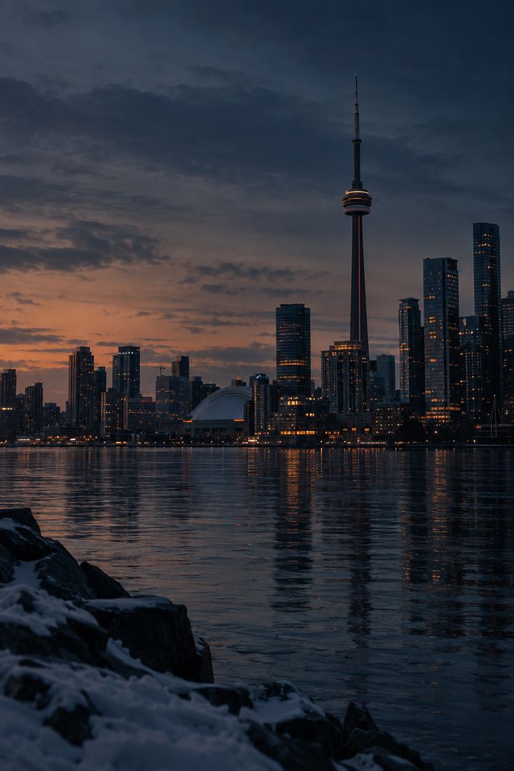 The Toronto skyline and the CN Tower at dusk across the water
