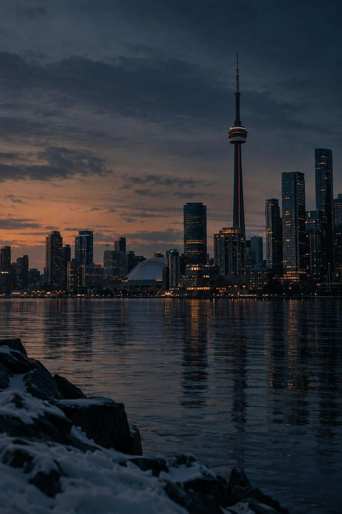 The Toronto skyline and the CN Tower at dusk across the water