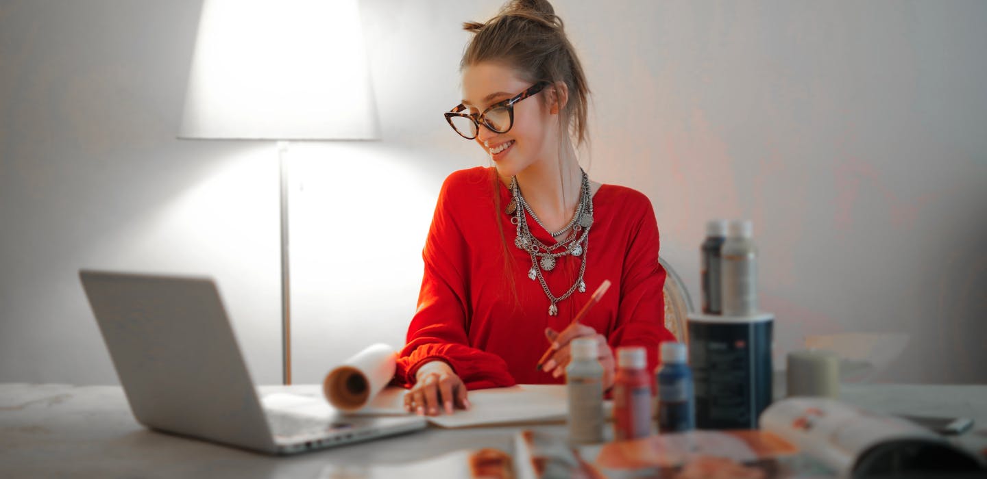 Female homeworker looking at laptop