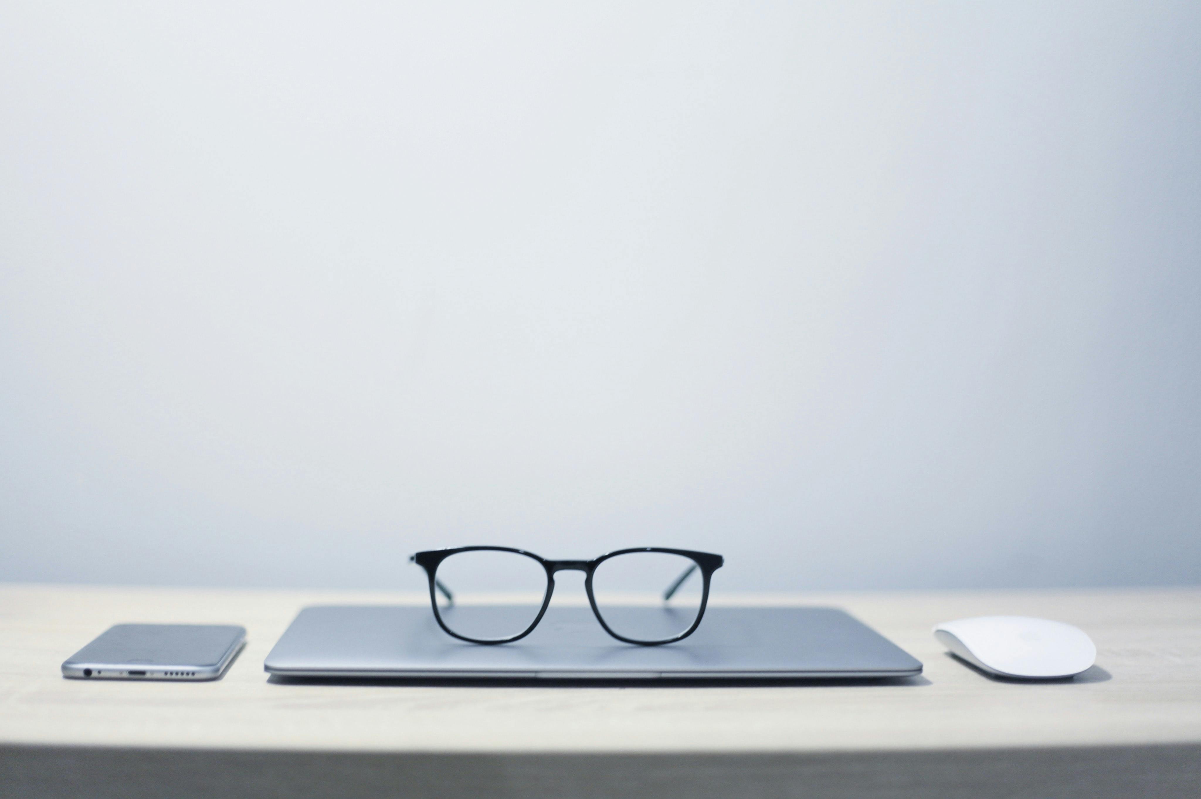 Glasses on top of laptop