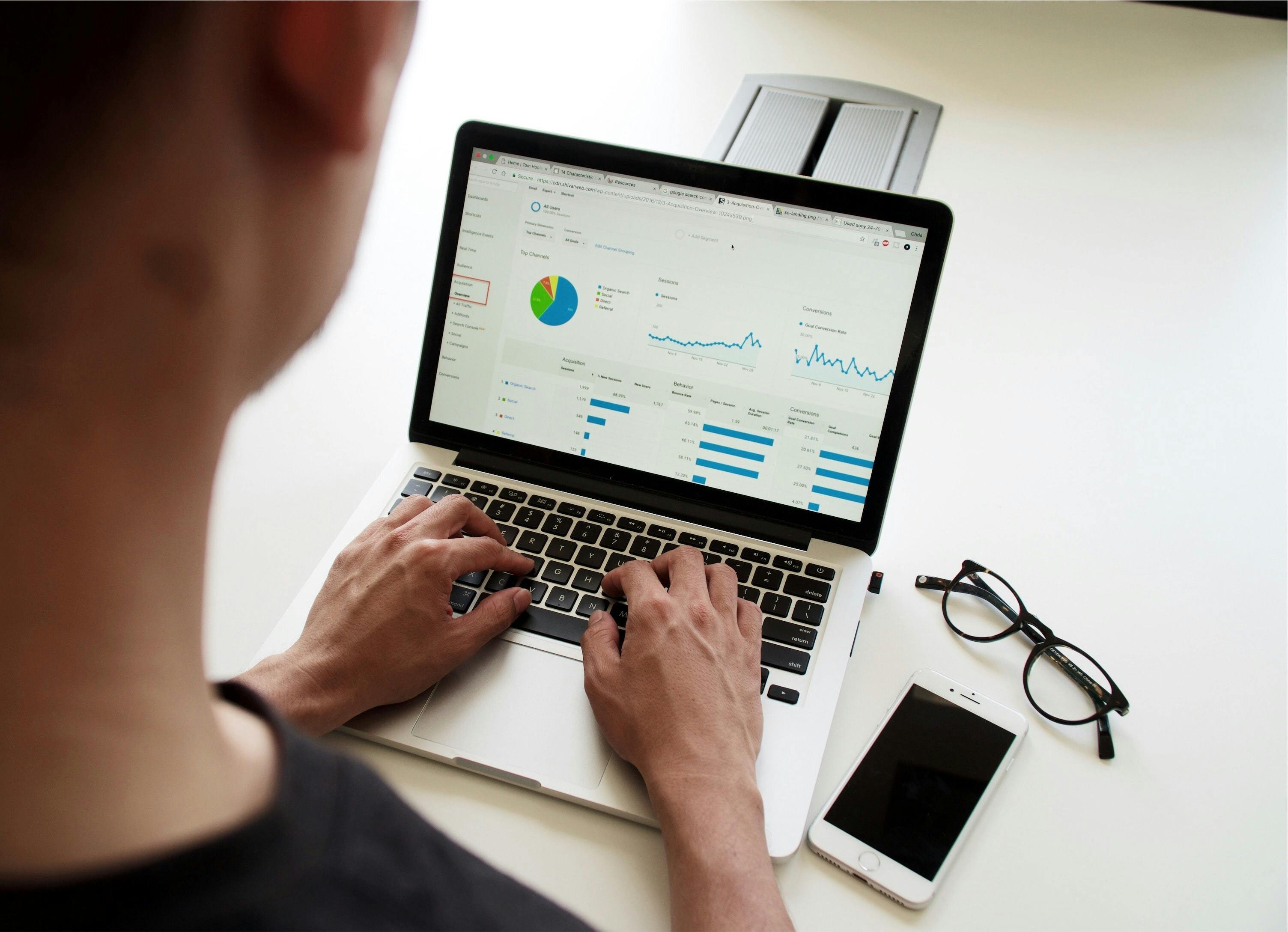 Man using a spreadsheet on a laptop