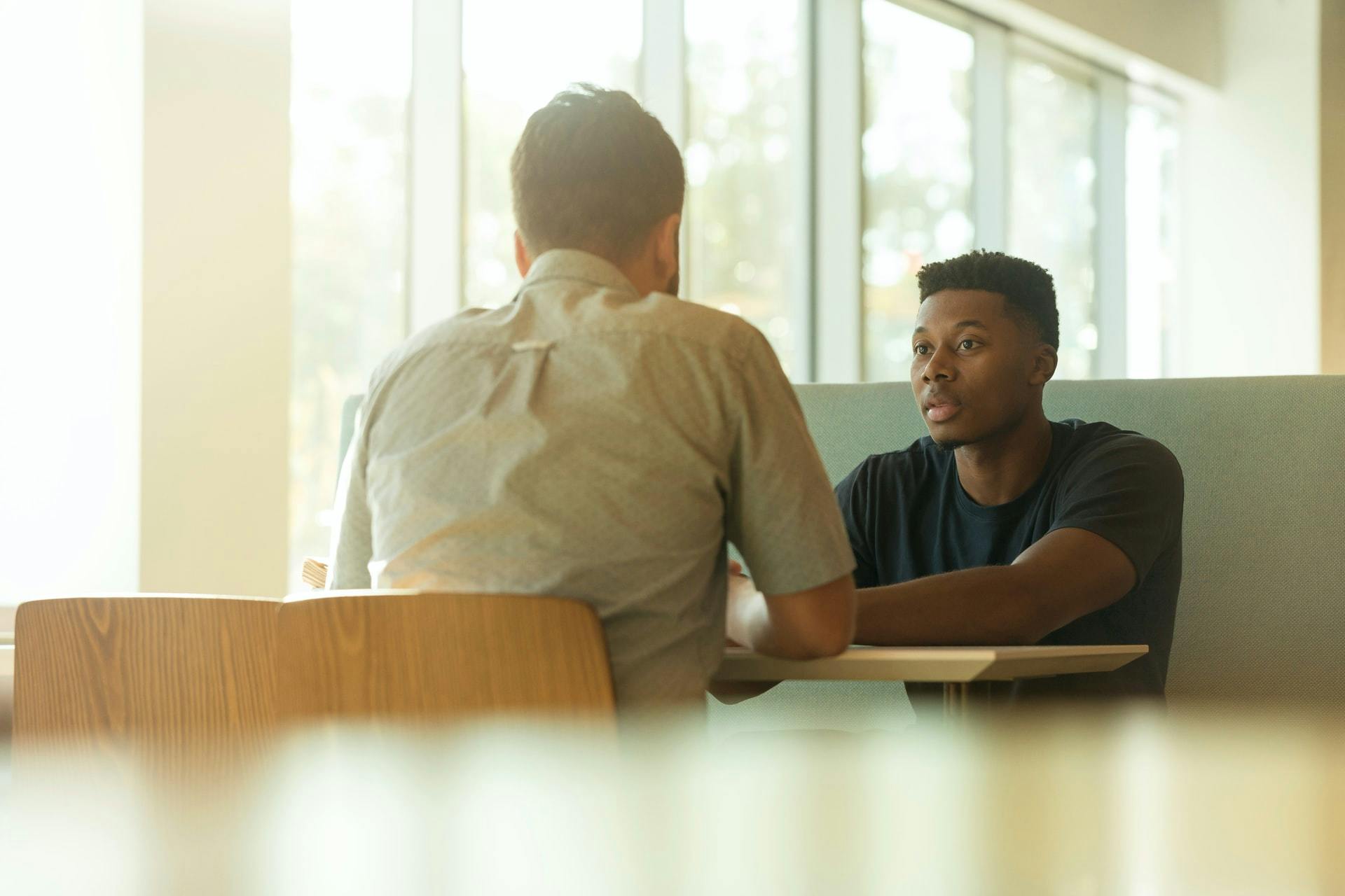 Redundancy meeting, two people talking in a light office