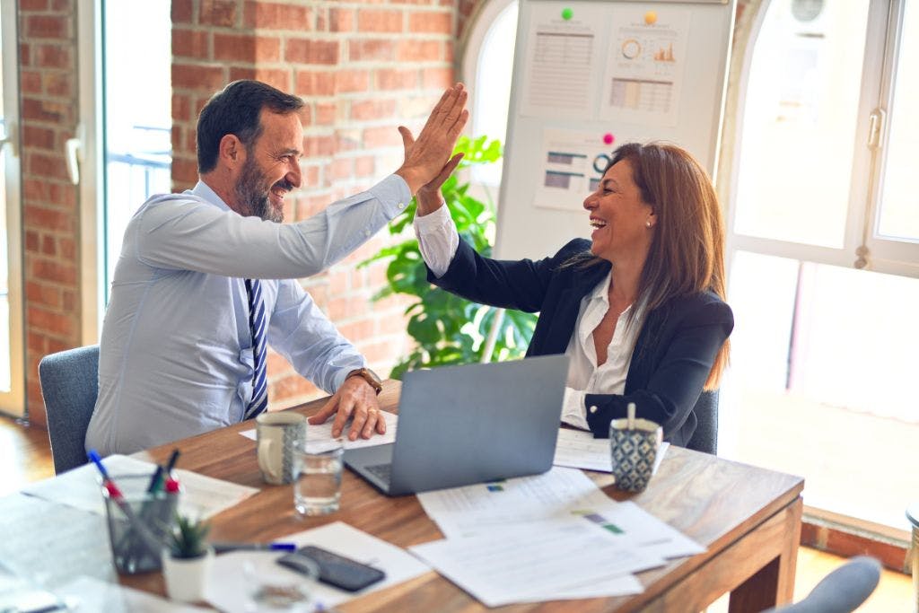 Positive one to one meeting Two people feeling positive due to substantial benefits