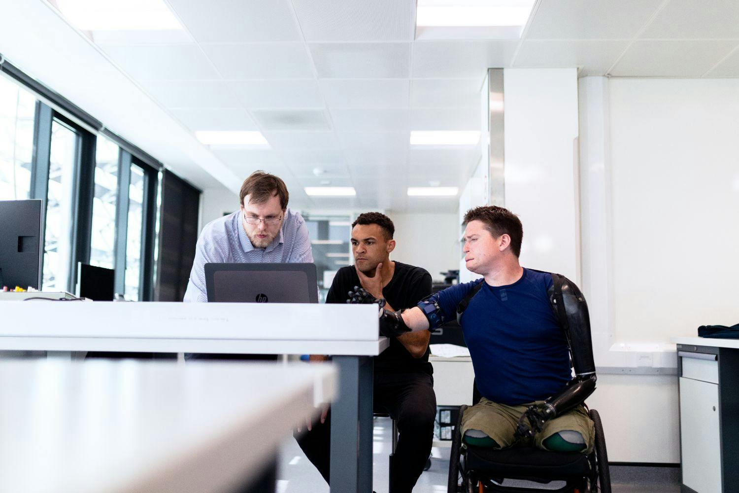 worker with prosthetic limbs with colleagues worker with prosthetic limbs with colleagues