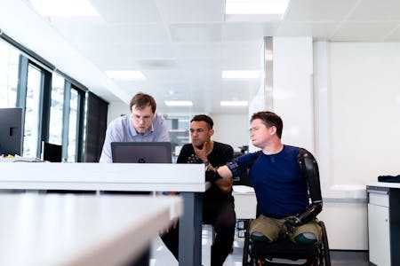 worker with prosthetic limbs with colleagues