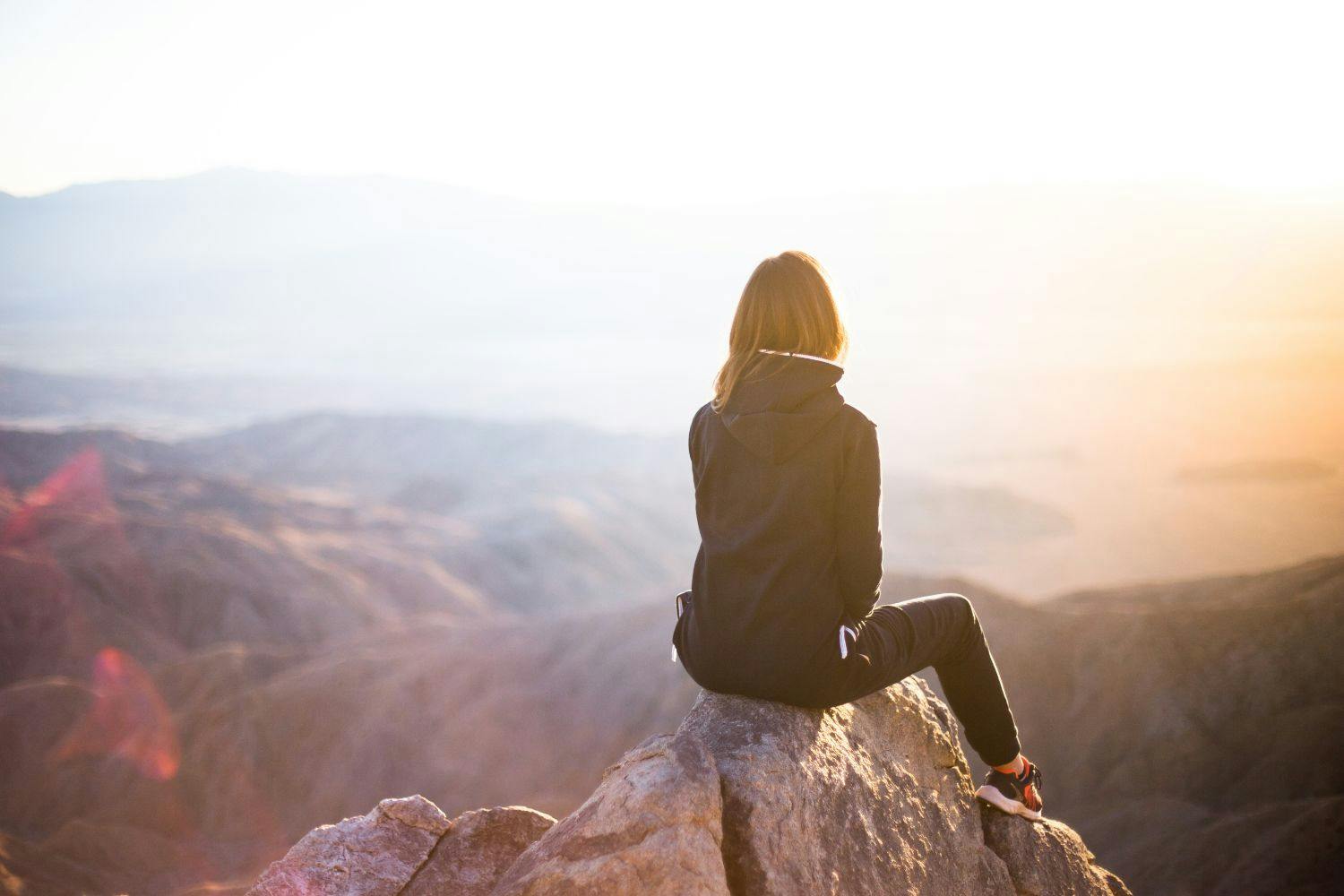 female at top of mountain