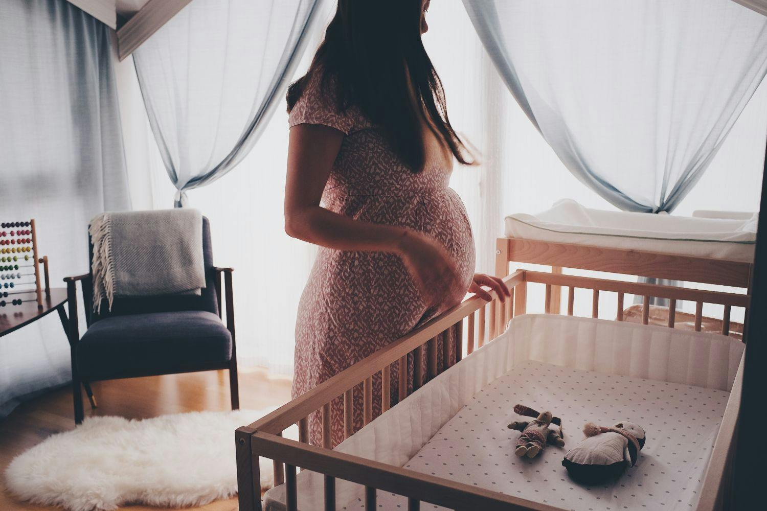 pregnant lady at a cot