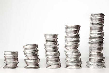 A stack of coins arranged in a pyramid shape, with varying sizes and angles.