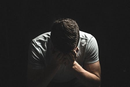 Workplace conflicts Man with his head in his hands.