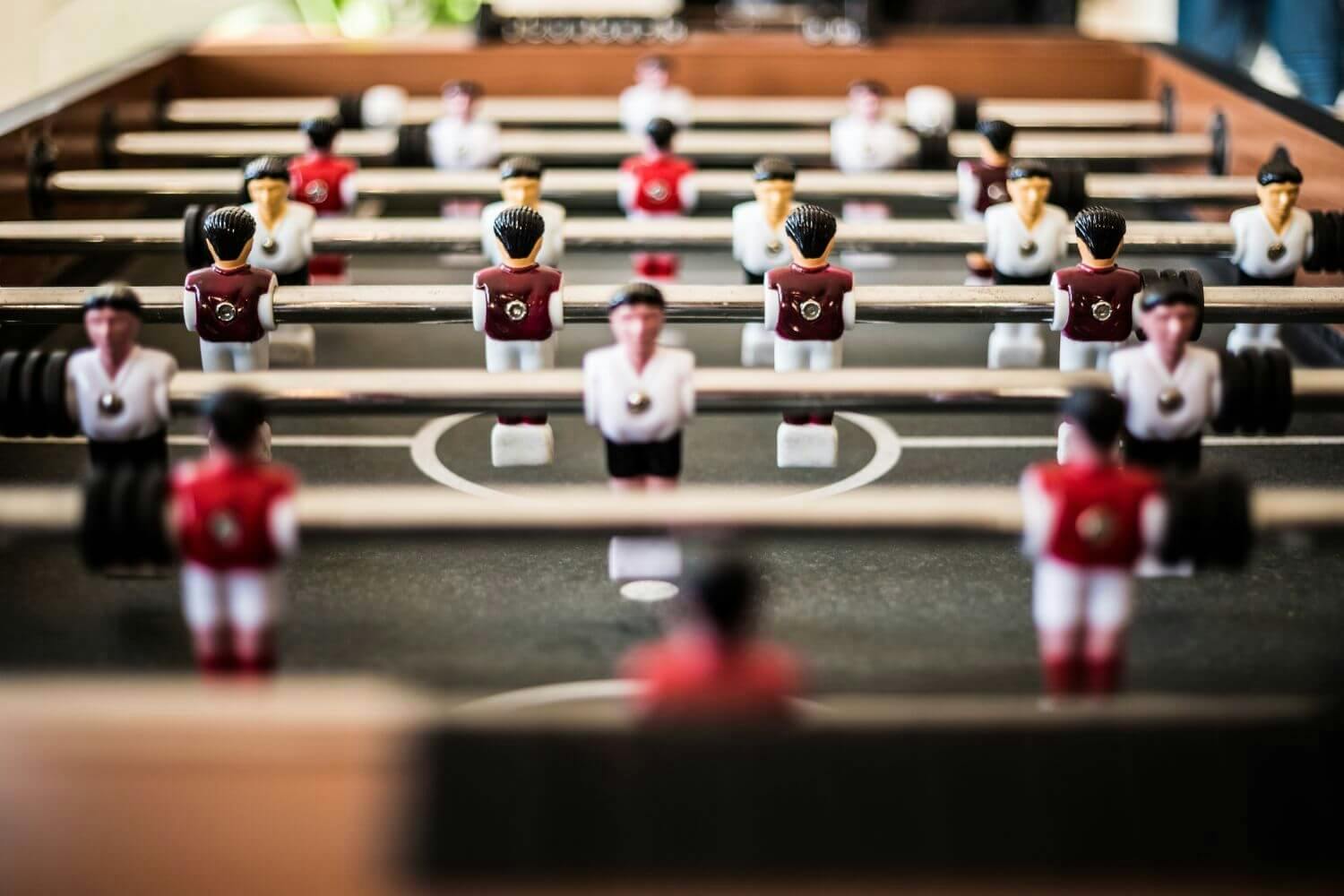 A close up of two table football teams working together