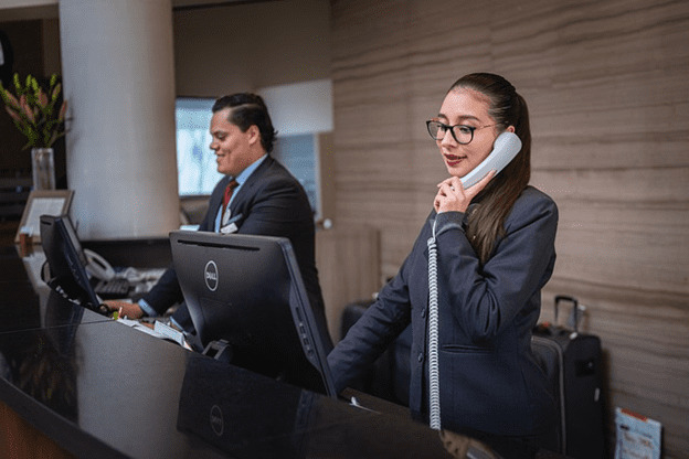 A staff member at work using a phone.