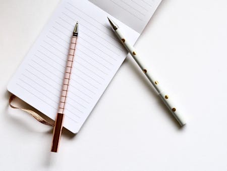 Notepad A notepad with two pens resting on it ready for a meeting