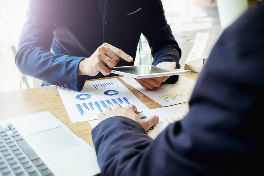 Two people meeting over documents working on a mission statement