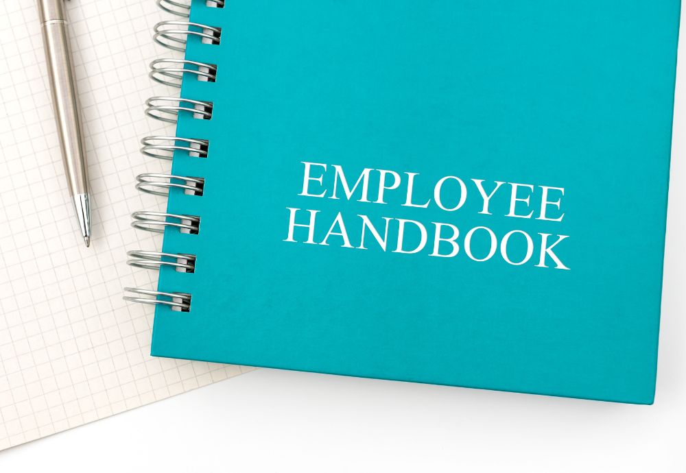 A Notepad containing the employee handbook