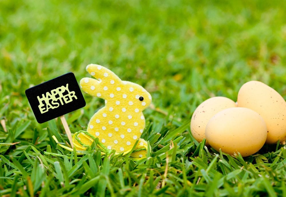 A toy rabbit with easter eggs and a Happy easter sign