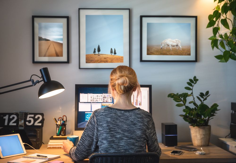 A person working from home at a desk reducing business costs of hiring out an office