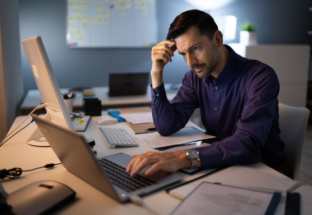 Person working late from home after struggling to unplug from work