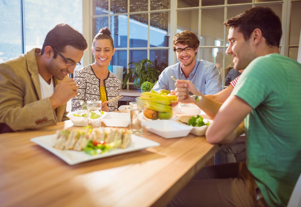 4 people having a free lunch provided by work as an employee benefit