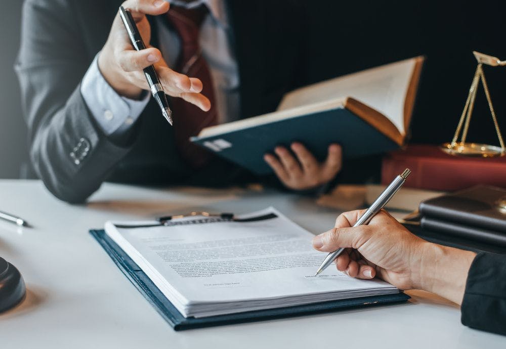 Lawyers going over legal documents around zero hour contracts