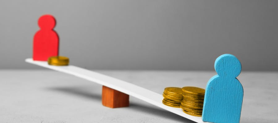 A blue man and a red woman on seesaw representing disparities in pay