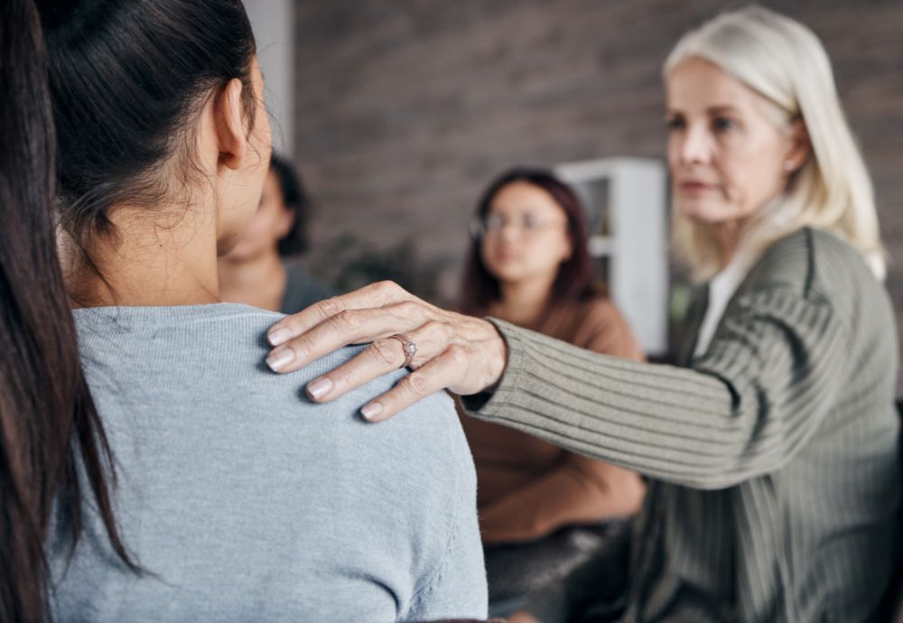 A person being comforted at work after coming back from Compassionate leave