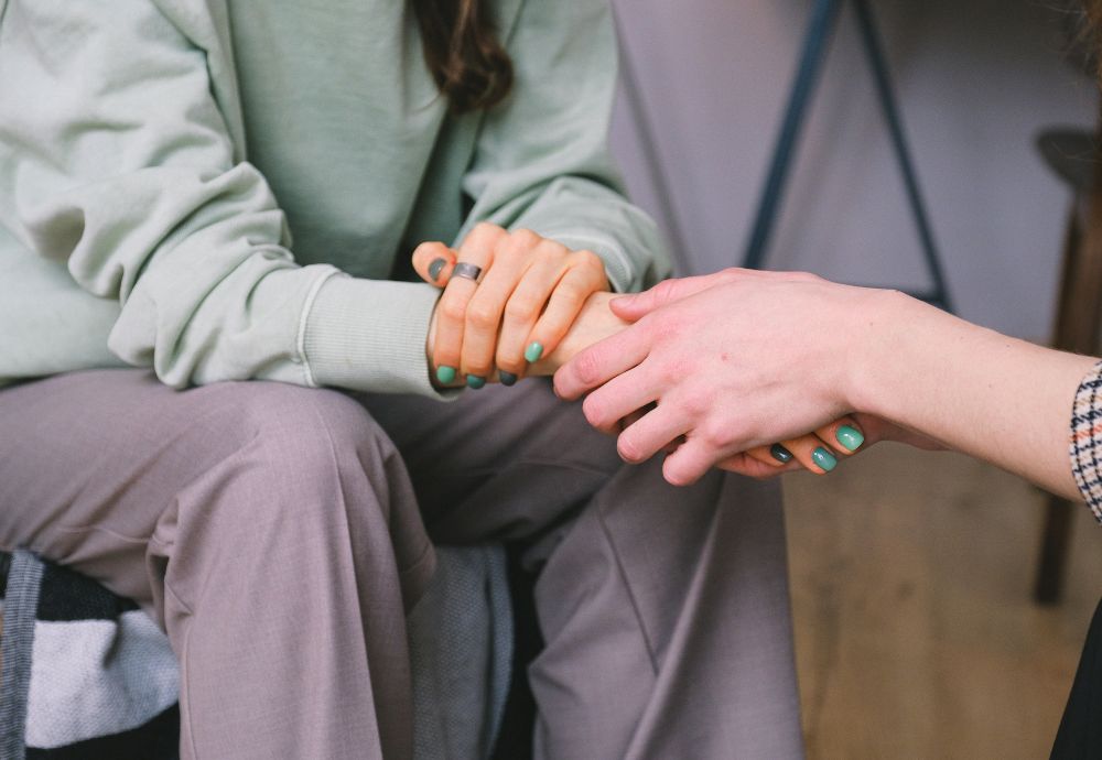 2 people holding hands after a recent bereavement and needing Compassionate leave