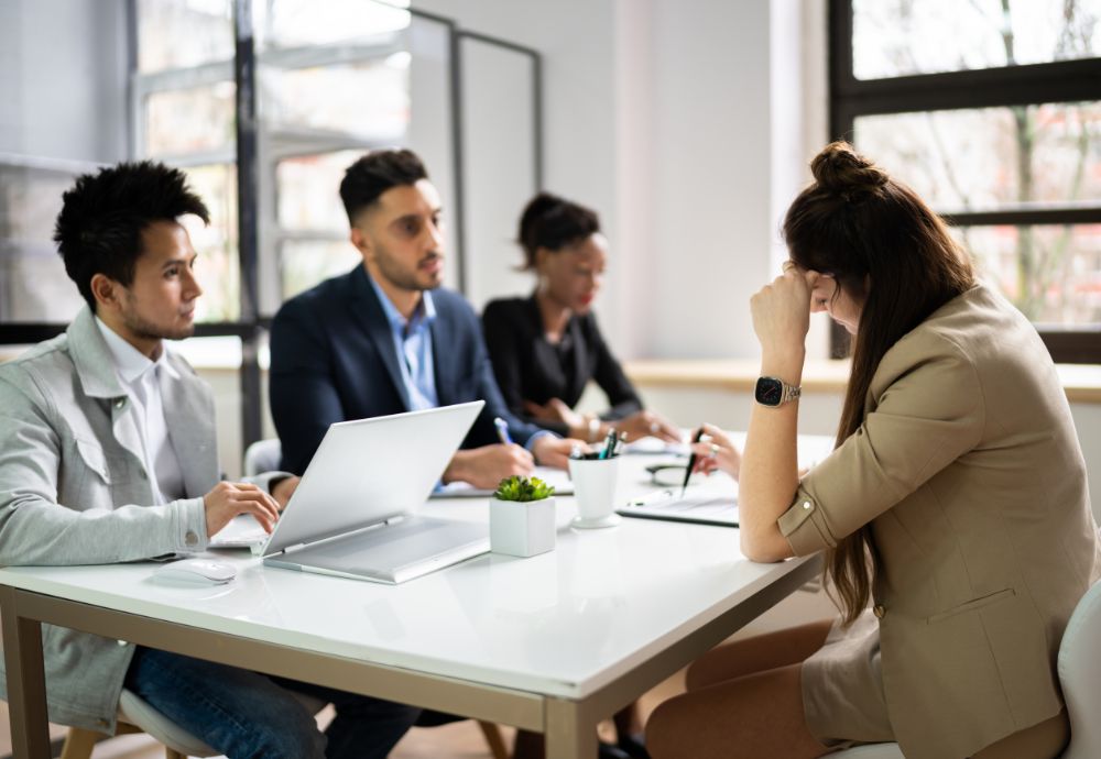 A group of people meeting over a contract to go over a payroll deduction