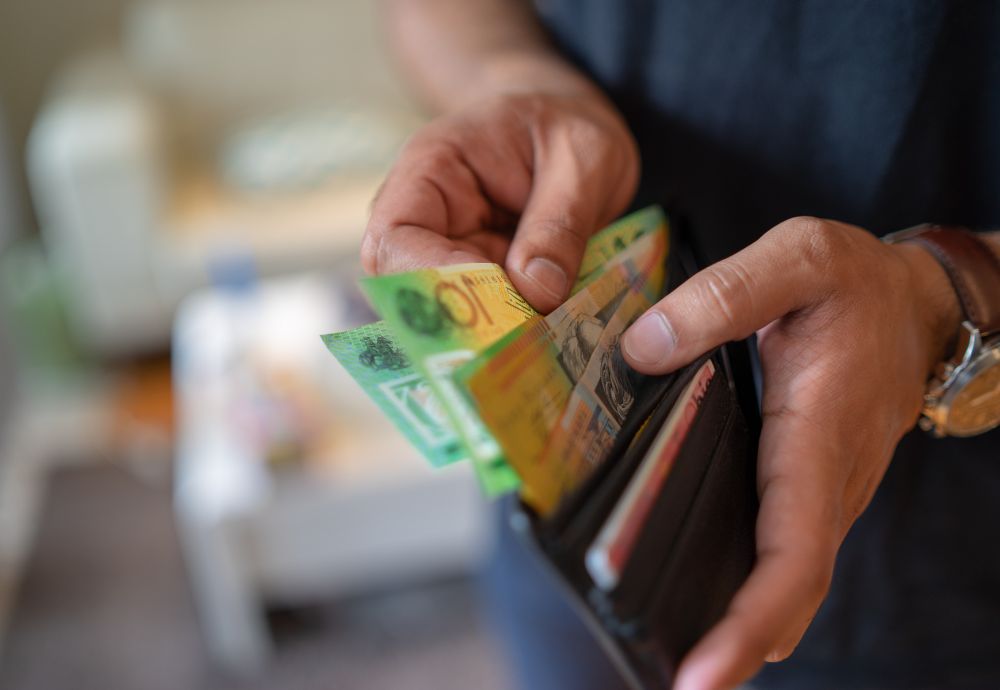 A man holding his pay after getting minimum wage