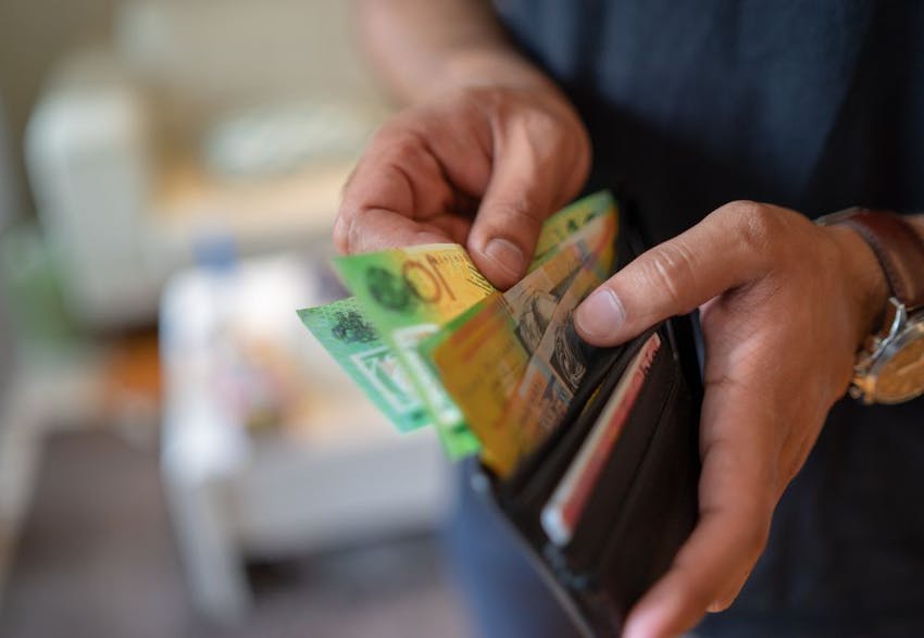 A man holding his pay after getting minimum wage