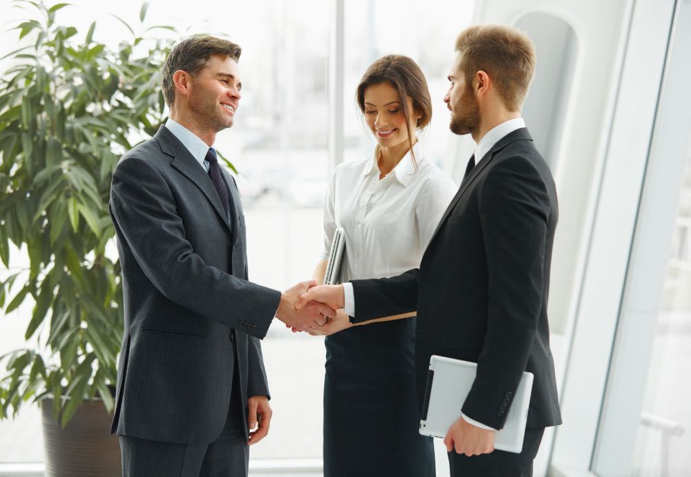 2 people shaking hands after reaching an agreement with a conciliator