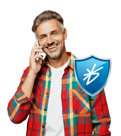A man stood smiling on the phone. In front of him is the BrightHR HR Defence logo: a blue shield icon with the BrightHR logo on the front.