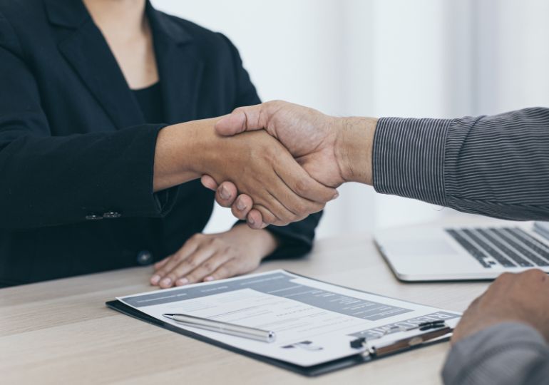 Two people shaking hands after finishing a job interview