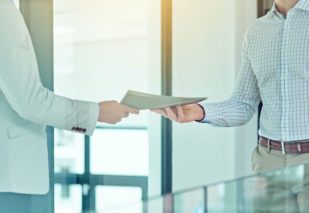 2 people handing over documents