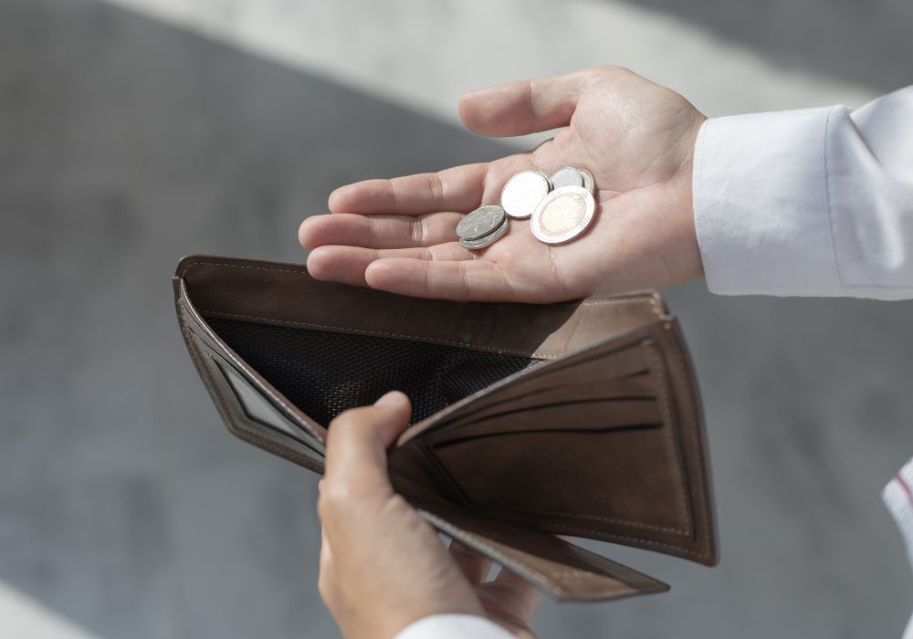 A person with pay grievances  holding a small amount of money