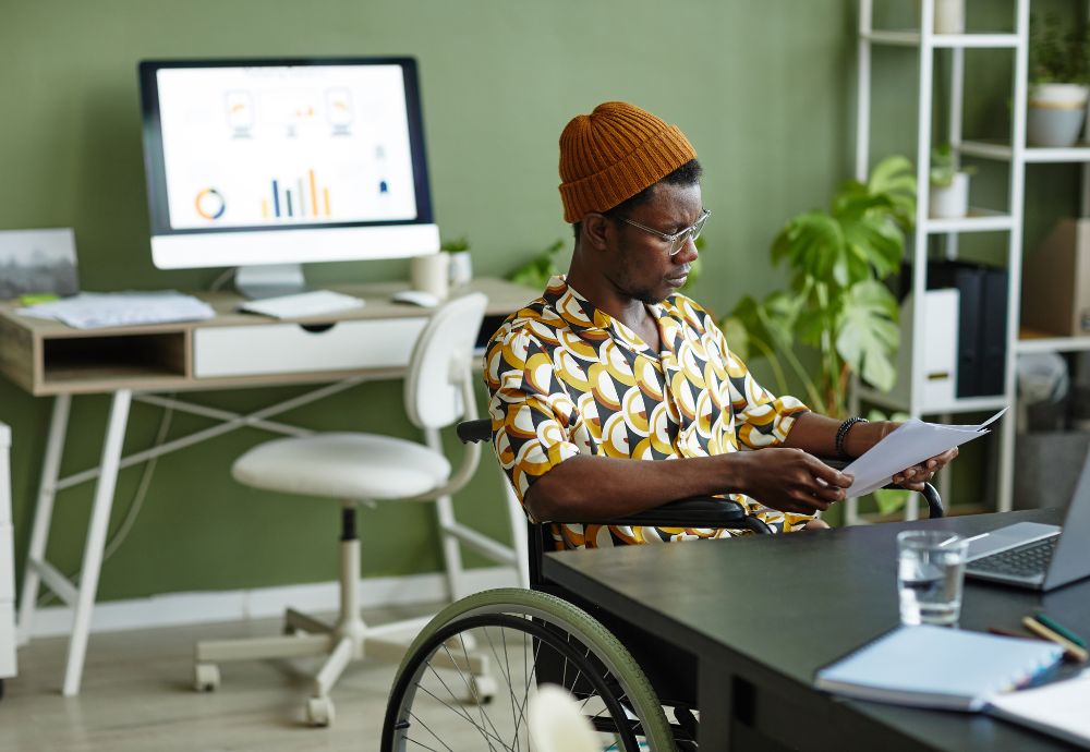 A person in a wheelchair who had the office adapted after a absence