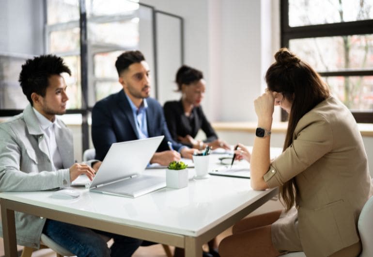 An employee being reviewed by 3 managers