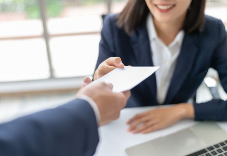 A person being handed their salary