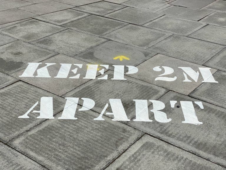 Keep 2m apart written on path