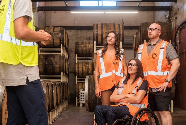 Manager inspiring staff that work in a distillery