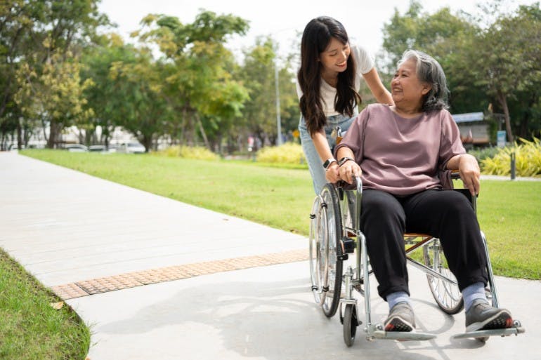 female employee on carers leave helping dependant on walk