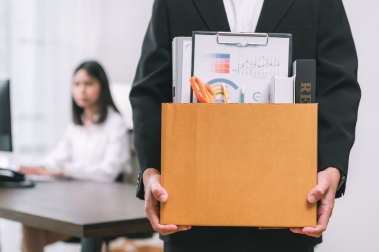 employee leaving job holding box